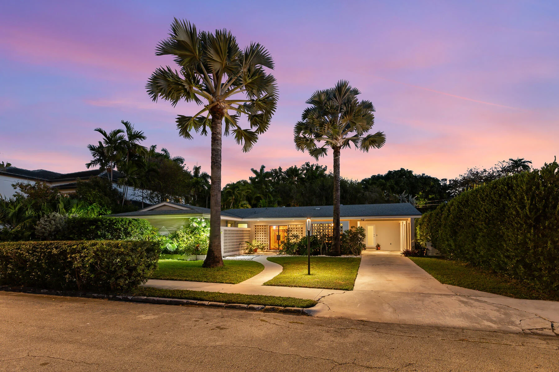 Mid-century Miami home at golden hour framed by palm trees